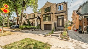 A modern two-story house with a garage, a front yard with a small lawn, and a driveway leading to the house. -  Bright, Cozy, Separate Entrance, Guest Room, Walk.: Subway, Shop, restaurants.. (Toronto)