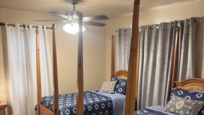 A four-poster bed with a ceiling fan, wooden flooring, and a bedside table with a lamp. - Stay Close to Everything  15 Min to Laughlin AFB (Del Rio)