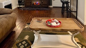 A living room with a flat-screen TV, a fireplace, a dining area with a table and chairs, and a sofa. - Stay Close to Everything  15 Min to Laughlin AFB (Del Rio)