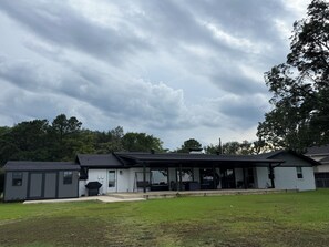 A two-story house with a covered porch, a small shed, and a grassy yard. - Lakefront with amazing views on beautiful Lake Hamilton in Hot Springs, Arkansas (Hot Springs)