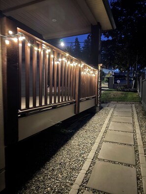 A covered outdoor area with a pathway leading to a gated entrance. - Cozy 2-bedroom suite near Mundy Park & Austin Heights (Coquitlam)