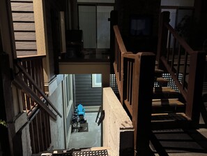 A wooden staircase leading to a balcony with a view of a house. - Cozy 2-bedroom suite near Mundy Park & Austin Heights (Coquitlam)