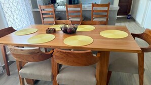 A wooden dining table with six chairs, each with a woven placemat. - Cozy 3-bedroom house with AC in charming, centrally located Masatepe, (Masatepe)