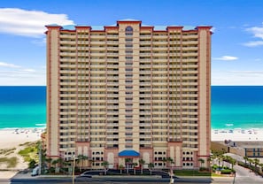 A high-rise hotel with multiple balconies, a beach view, and a central entrance. - 22nd Floor Gulf-Front Escape, Sunrise Beach Resort, Resort Pools, Sleeps 7 (Panama City Beach)