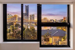 A window with a cityscape view including a bridge, buildings, and a residential area. - Groovy! ~ Central New Farm ~ Walk to CBD (Brisbane)
