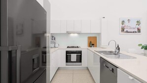 A modern kitchen with white cabinets, a stainless steel refrigerator, a built-in oven, and a dishwasher. - Hidden Oasis 2bed-2bath-1car - 5 Mins to CBD (Brisbane)