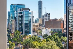 A cityscape with modern buildings, including a prominent glass skyscraper with the name 'Allianz' and a unique building with a curved roof. - City Living! 1bed/1bath/pool (Brisbane)
