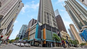 A tall urban building with a modern design, surrounded by other high-rise structures. - Inner-city Vibes! 2bed/1bath/1car/balcony~cbd (Brisbane)
