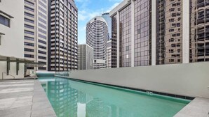 A swimming pool with a clear view of adjacent high-rise buildings. - Inner-city Vibes! 2bed/1bath/1car/balcony~cbd (Brisbane)
