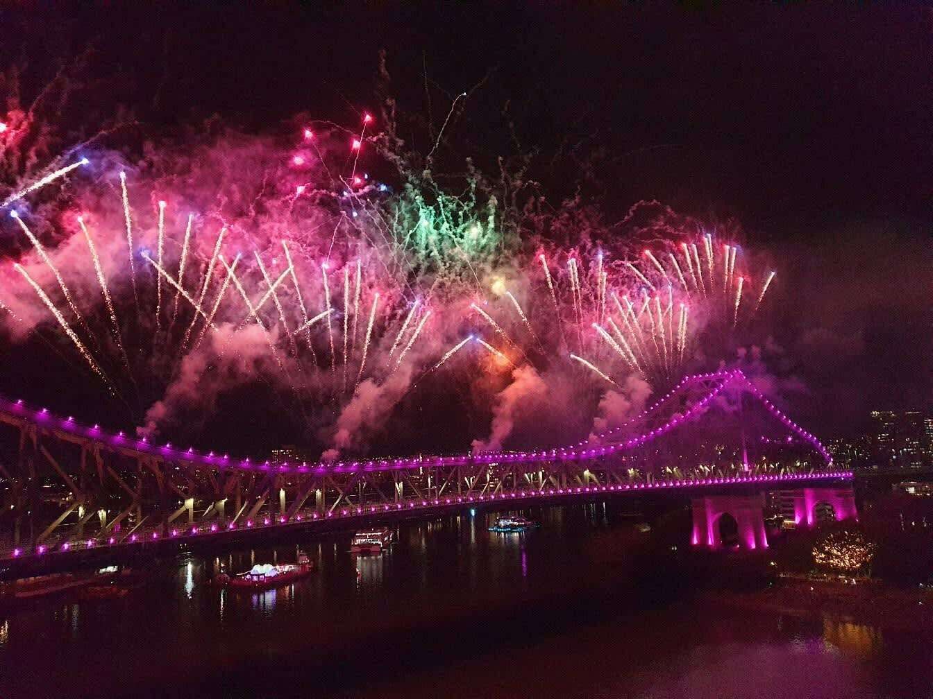 A bridge with fireworks in the background.