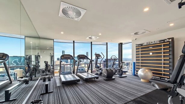A modern gym with treadmills, elliptical machines, and free weights. - Top Floor! 2bed/2bath/1car/pool ~ Views ~ CBD (Brisbane)