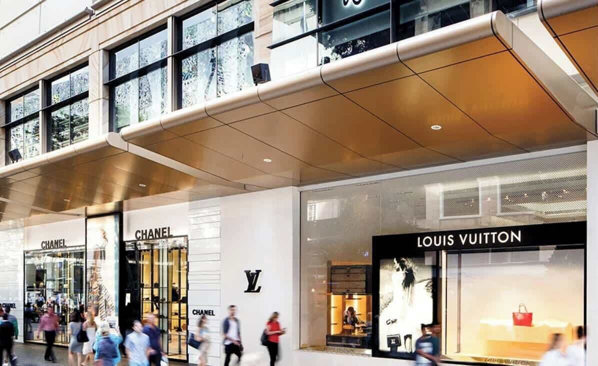 A shopping mall with Chanel and Louis Vuitton stores.