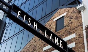 A building with a sign that reads 'FISH LANE.' - South Bank Styling! ~ 1bed, 1bath, 1car, Balcony (Brisbane)
