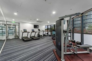 A gym with treadmills, stationary bikes, and weight machines. - Skyhigh Executive! ~ 2bed/2bath/1car/views ~ CBD (Brisbane)