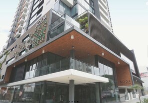 A modern building with a glass facade, a reception area, and a sign reading 'SODA.' - South Bank Stunner! ~ 3 Bed/2 Bath/1car/views (Brisbane)