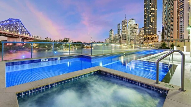 A swimming pool with a city skyline and a bridge in the background. - Spectacular! 2bed, 1bath, 1car, Views ~ CBD (Brisbane)