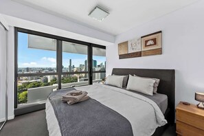 A modern bedroom with a large bed, a city view, and a minimalist decor. - Infinity Excellence!~1bed/1bath/office/1car~views! (Brisbane)