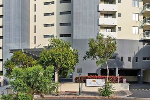 A multi-story building with a modern architectural design, featuring balconies and a sign indicating the address. - Stunning! 2bed, 1bath, 1car, Views ~ CBD (Brisbane)