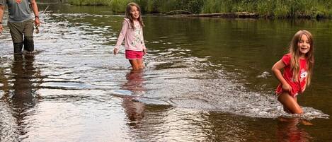 A river with people wading through it.