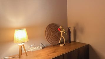 A wooden console table with a lamp, a decorative item, and a vase.