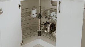 A kitchen with a corner sink, a coffee maker, and a toaster on the countertop. - Cosy central guest house (Bellerive)