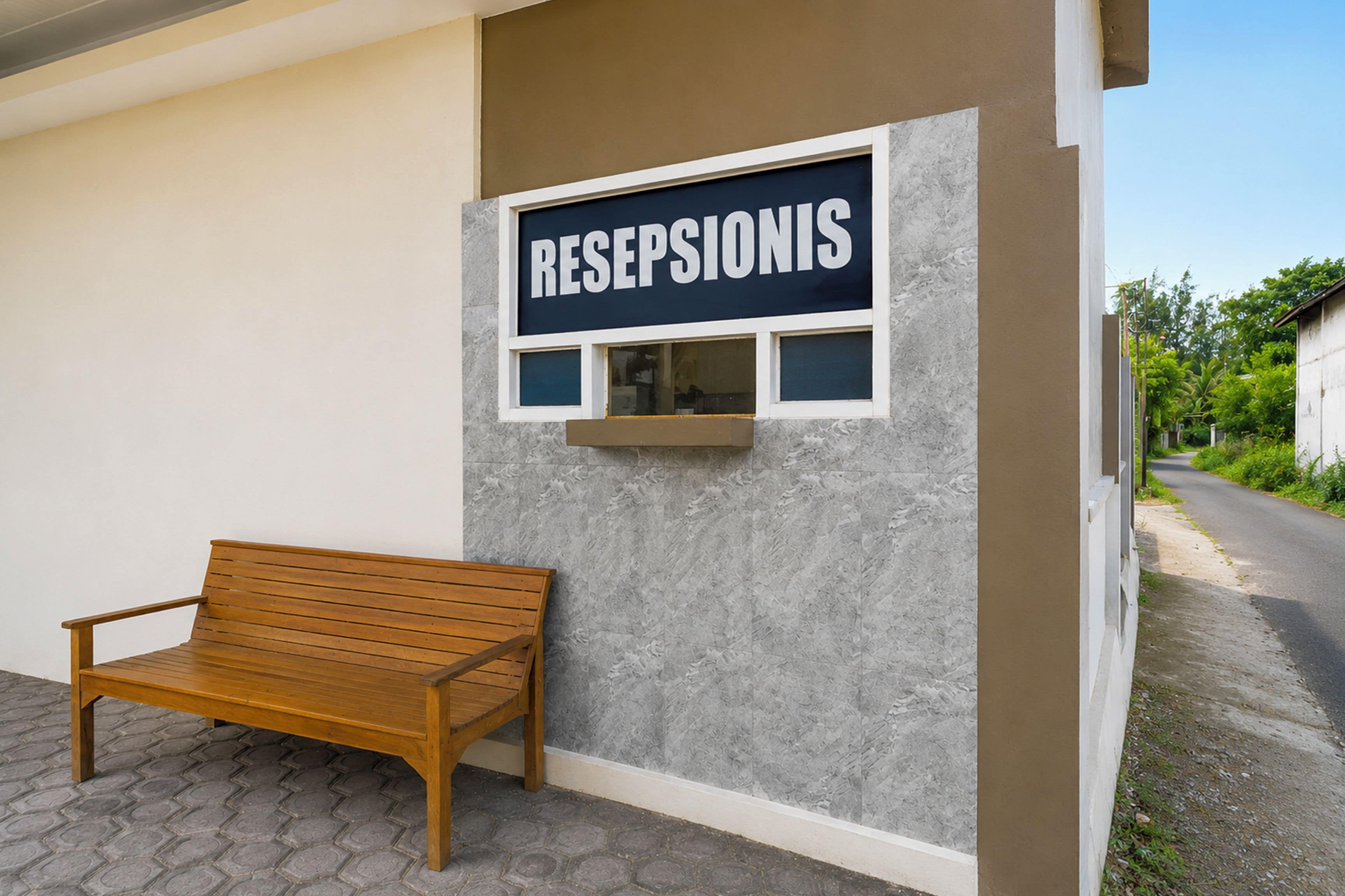A reception desk with a sign reading 'RESEPSIONIS' and a wooden bench outside.