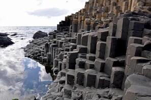 A stone structure with a stepped design, likely a historical or cultural site. - Little Lake Lodge Retreat Sleeps 2 with Parking (Ballycastle)