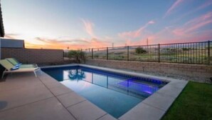 A swimming pool with a fence and a sunset view. - Saltwater Pool, Spa & Casita  Terra Lago (Indio)