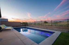 A swimming pool with a fence and a sunset view. - Saltwater Pool, Spa & Casita  Terra Lago (Indio)