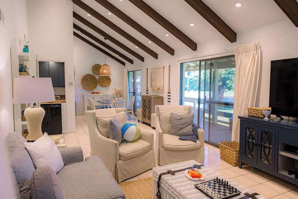 A modern living room with sofas, a television, and a chessboard.