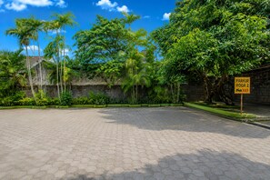 A paved parking area with a sign indicating 'PARKIR RODA 2'. - OYO 95373 Giriwardoyo Family Guest House (Depok)