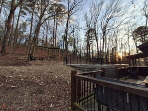 A park with a wooden deck, benches, and a fence. - Three Bears Cabin | Included Heated Pool, Hot Tub & Mountain Views Near Hochatown | Pet-Friendly (Broken Bow)