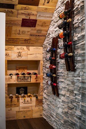 A wine cellar with wooden crates and a wine rack against a stone wall. - Bluebird Reserve: Dome • Sauna • Hot-Tub • Cold Plunge • Fire-Pit • Putt • Views (Mineral Bluff)