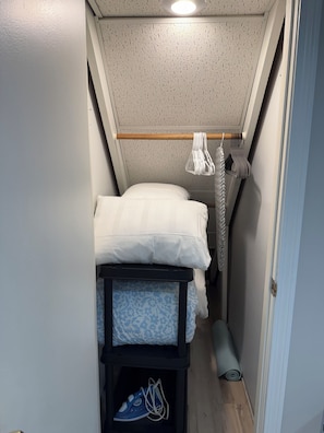 A narrow room with a bed, a small storage unit, and a ceiling light. - The Modern Garden Suite: With Private Entrance ~ 1 BR - sleeps 3 (Manchester)