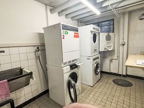 A laundry room with a washing machine, dryer, and a water heater. - Skyline Apartment 203 on Lake St. Moritz by Interhome (St. Moritz)