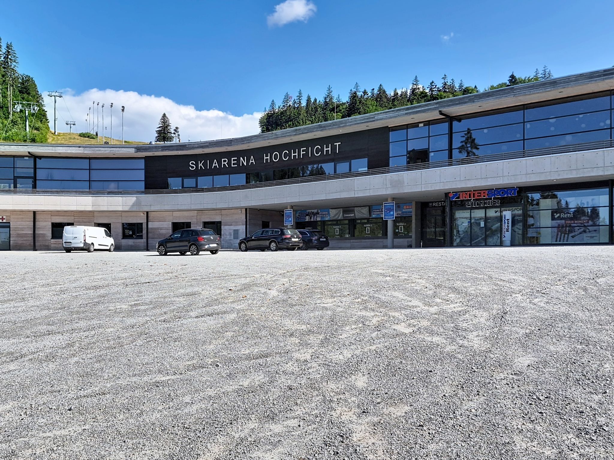 A modern building with a sign reading 'SKIARENA HOCHFICHT'.