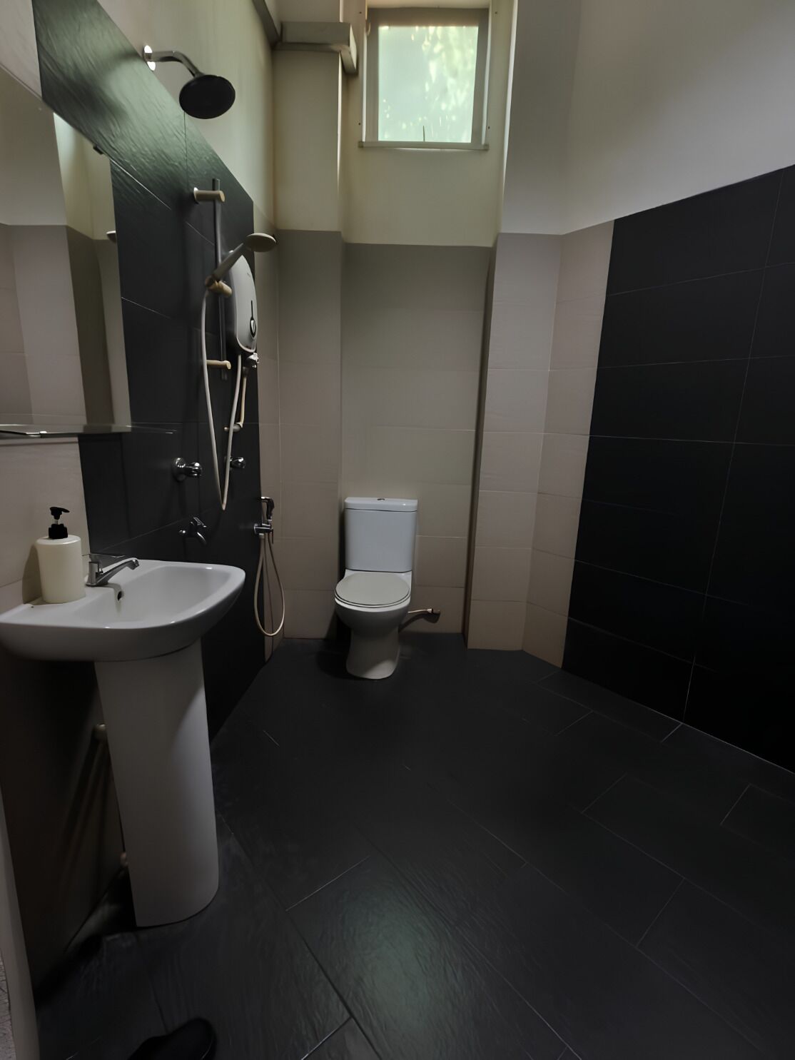 A bathroom with a sink, toilet, and shower.