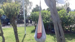 A hammock hanging between trees in a grassy outdoor area. - 4 Star Holiday Home in Vaeggerlose (Vaeggerlose)
