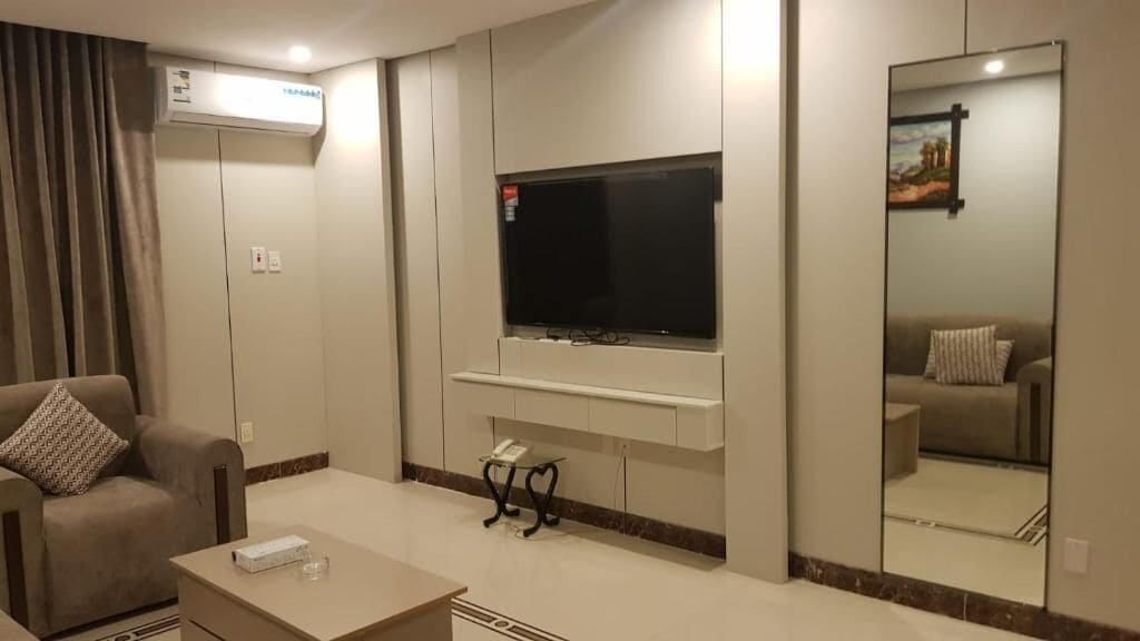 Apartamento Deluxe | Zona de estar | Una impresora