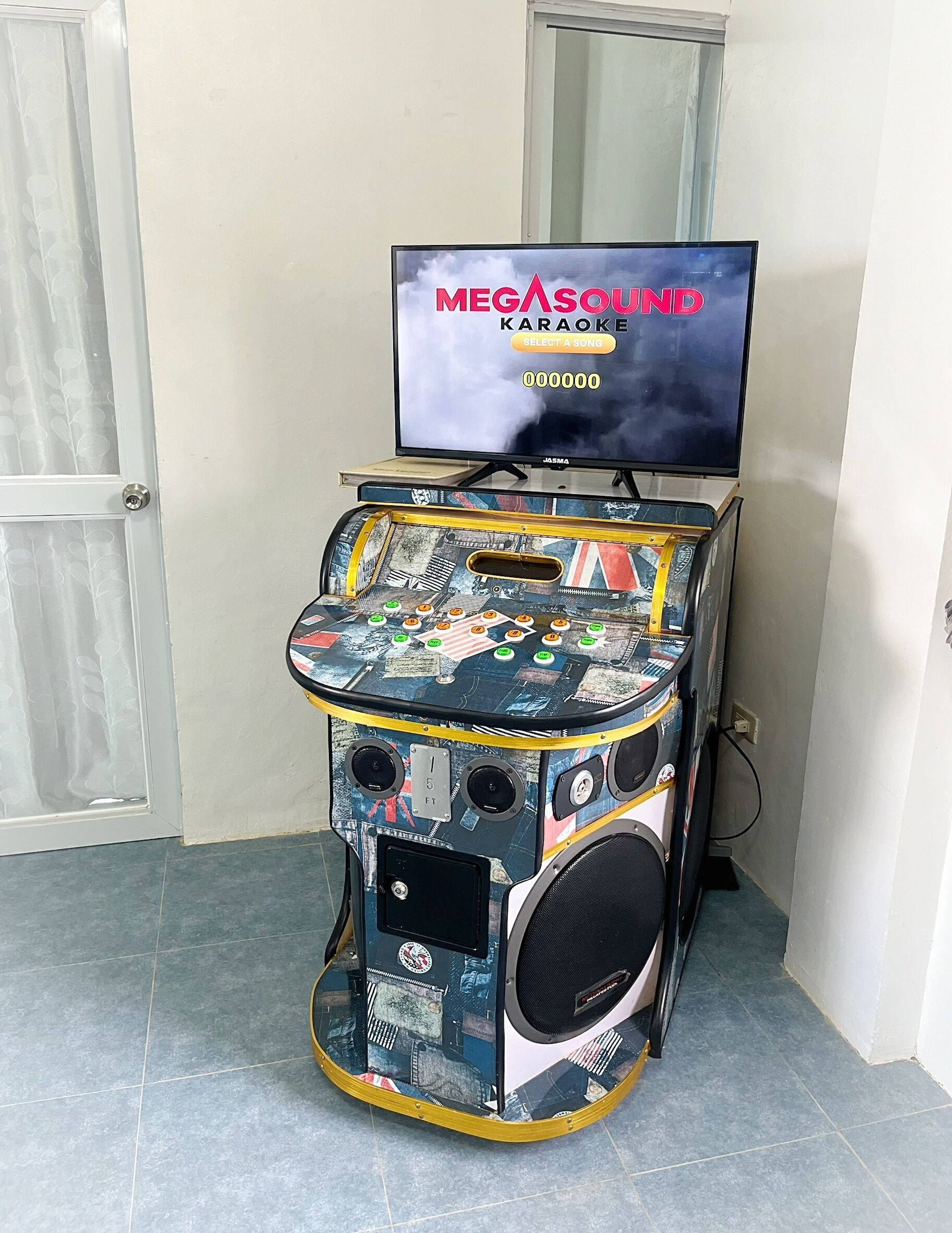 A karaoke machine with a screen displaying 'MEGASOUND Karaoke' and a selection menu.