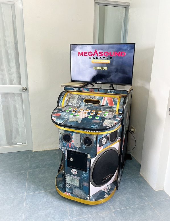 A karaoke machine with a screen displaying 'MEGASOUND Karaoke' and a selection menu.