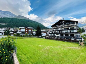 A hotel with multiple floors, balconies, and a view of mountains. - Hotel Alpin Superior (Saas-Fee)
