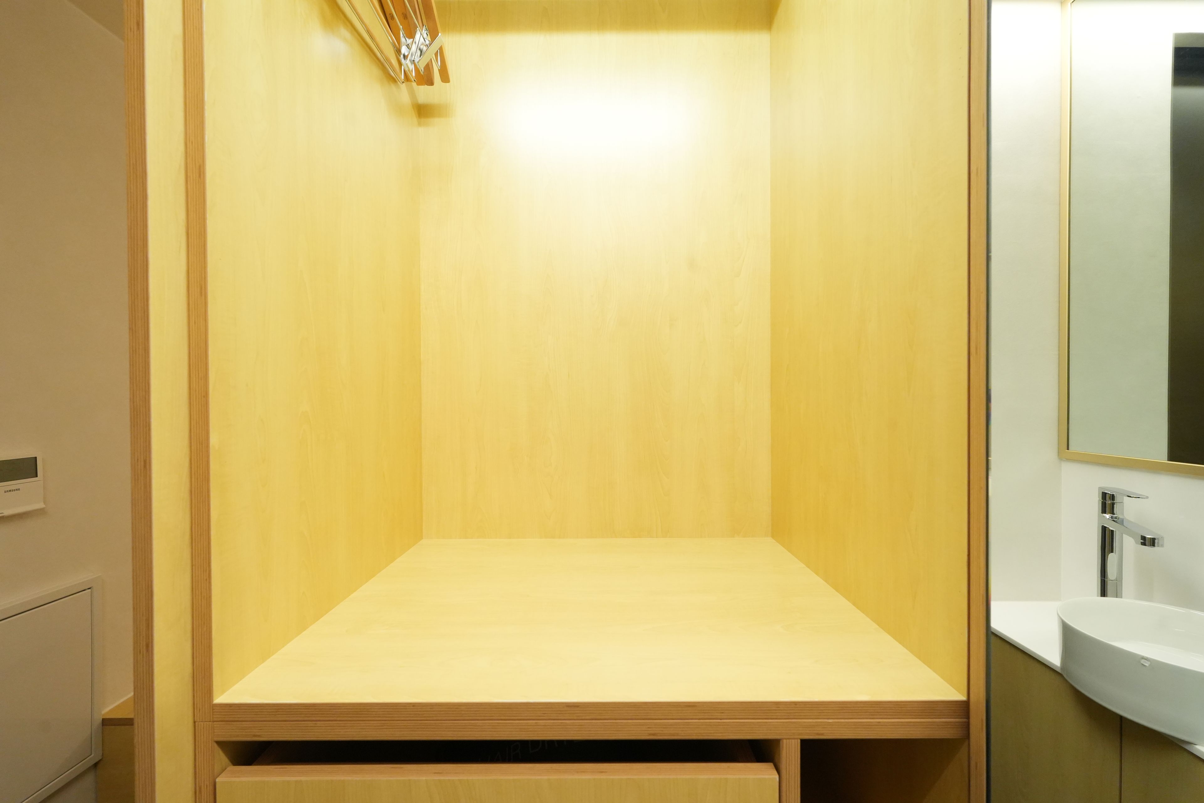 Une salle de bain avec un meuble-lavabo en bois, un miroir et un lavabo.