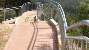 A metal staircase leading to a viewpoint overlooking a valley with distant mountains. - “Highly rated Blackheath garden studio — 4.94 from over 1,000 Airbnb guests” (Blackheath)