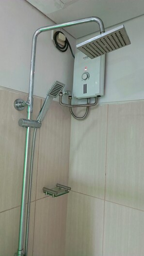 A shower with a handheld showerhead, a wall-mounted control panel, and a glass shelf. - Enjoyable 1-bedroom condo with AC in Pasay City (Pasay City)