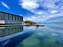 A modern building with a reflective pool in front.