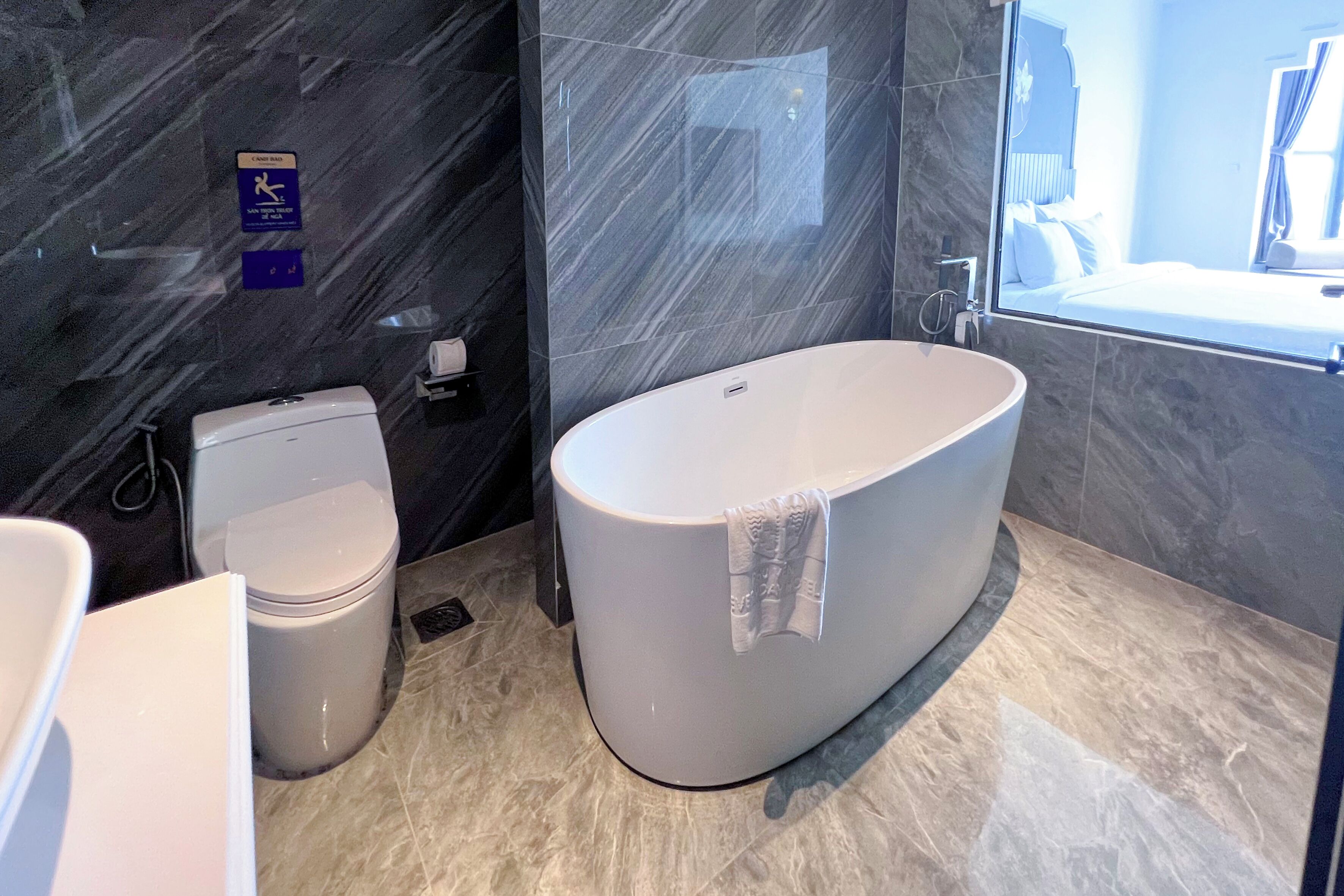 Une salle de bain moderne avec une baignoire sur pieds, des toilettes et un espace douche.