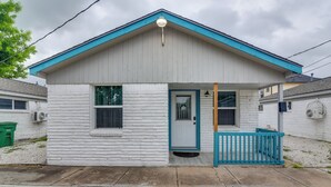 A small, single-story house with a blue roof and white exterior, featuring a front porch with a blue railing. - Dual Houston Homes: 6 Mi to NRG & Med Center (Houston)