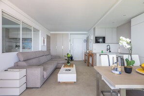 Eine moderne Wohnung mit Wohnzimmer, Küche und Essbereich.