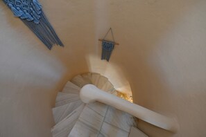A spiral staircase with a white handrail and a light-colored wall. - Dioni Tinos sea View Elegant Villa (Tinos)